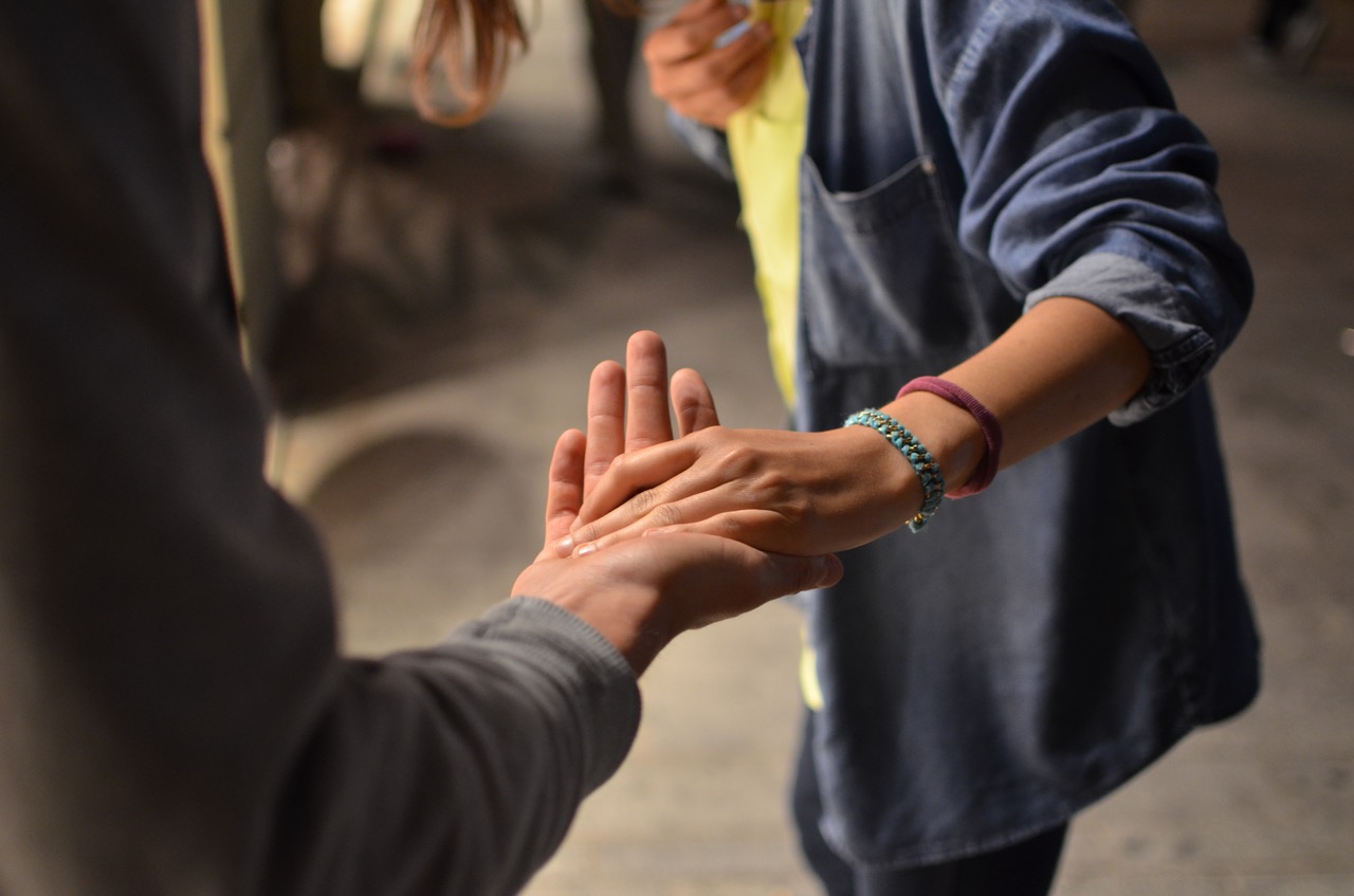 Holding hands with friends getting treatment at Center of Excellence